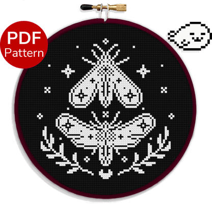 cross stitch pattern of a moth in black and white with moon and stars in the background