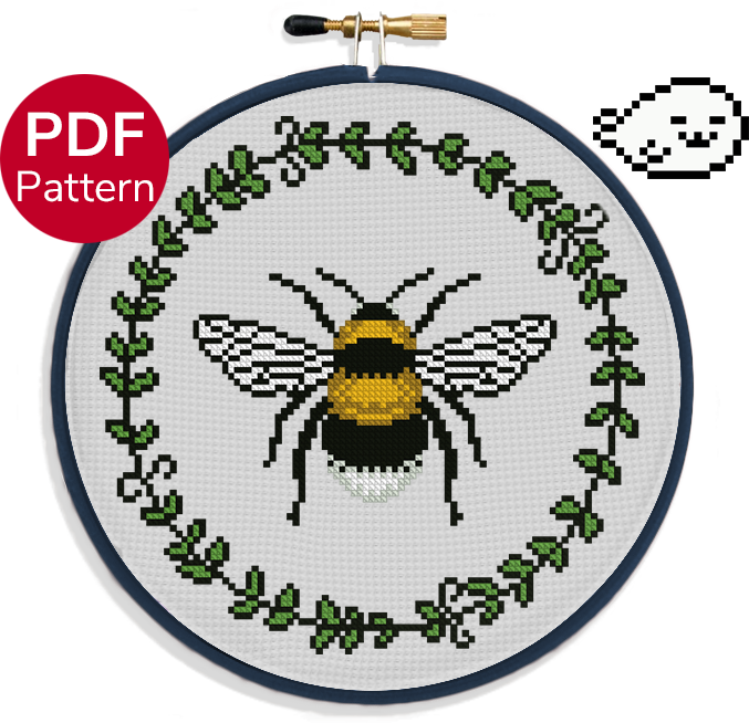 cross stitch pattern of a bumblebee surrounded by a leaf wreath