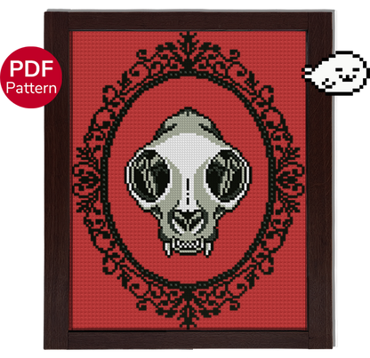 cross stitch pattern of a cat skull with an ornate gothic motif around