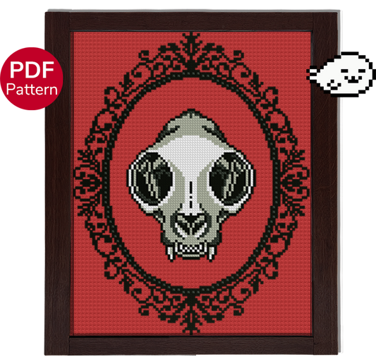 cross stitch pattern of a cat skull with an ornate gothic motif around