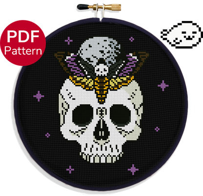 cross stitch pattern of the death's-head hawkmoth moth, on top a human skull