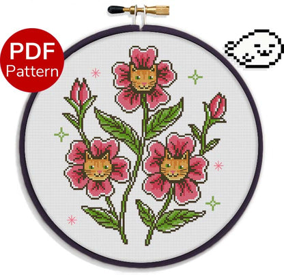 cross stitch pattern of pink flowers with orange cat faces in the middle of the petals