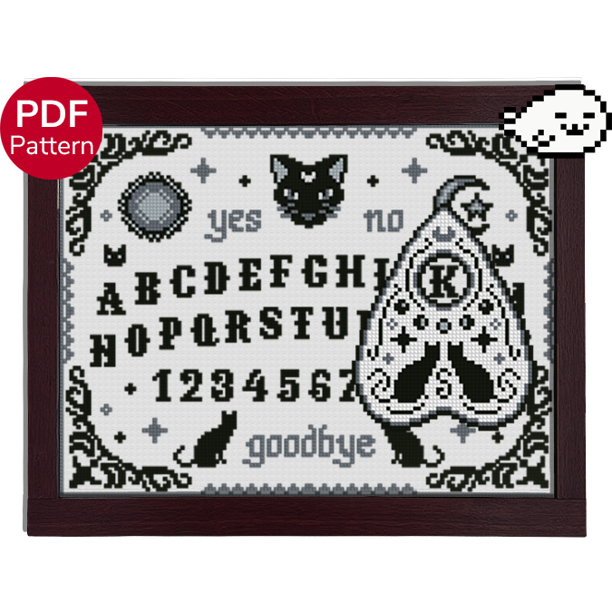 cross stitch pattern of a ouija board and planchette, with a cat theme and motifs