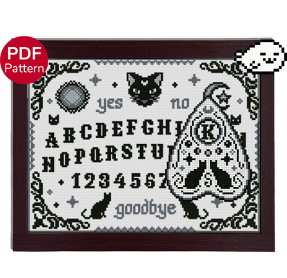 cross stitch pattern of a ouija board and planchette, with a cat theme and motifs