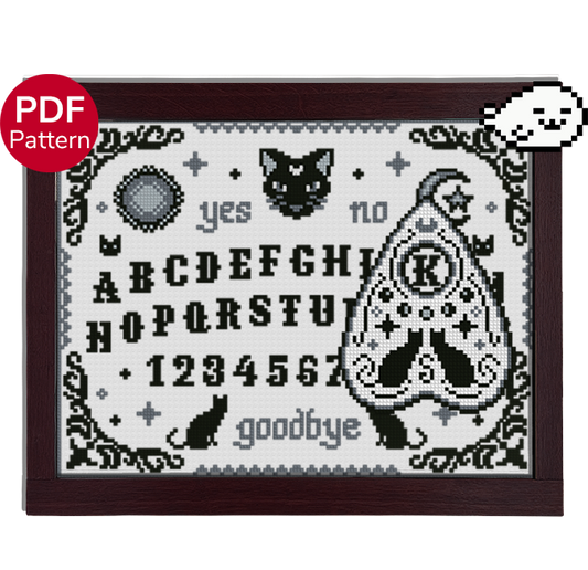 cross stitch pattern of a ouija board and planchette, with a cat theme and motifs