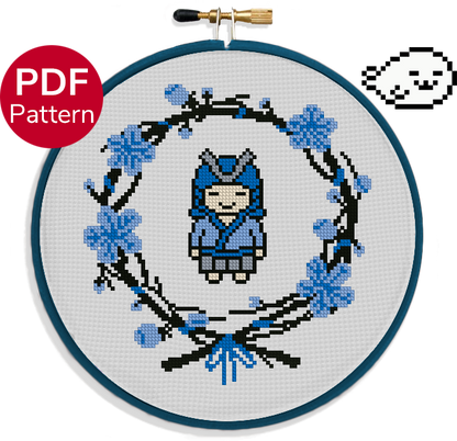 cross stitch pattern of a cute samurai dressed in blue and surrounded by a blue flower wreath