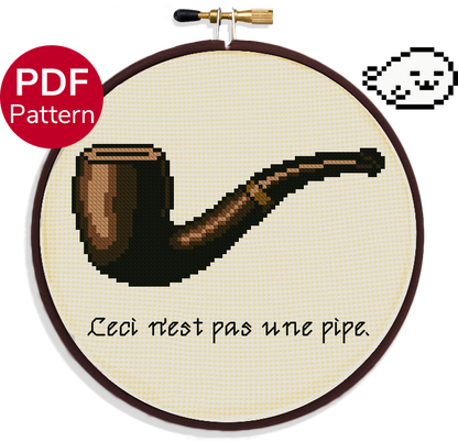 cross stitch pattern of a smoking pipe from the painting 'treachery of images' from Magritte, it has the quote "ceci n'est pas une pipe." which translates to 'this is not a pipe'