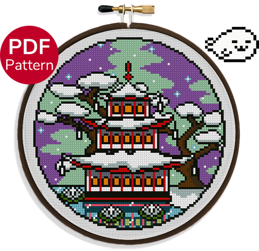 cross stitch pattern of a pagoda with snow covered roofing during the season of winter